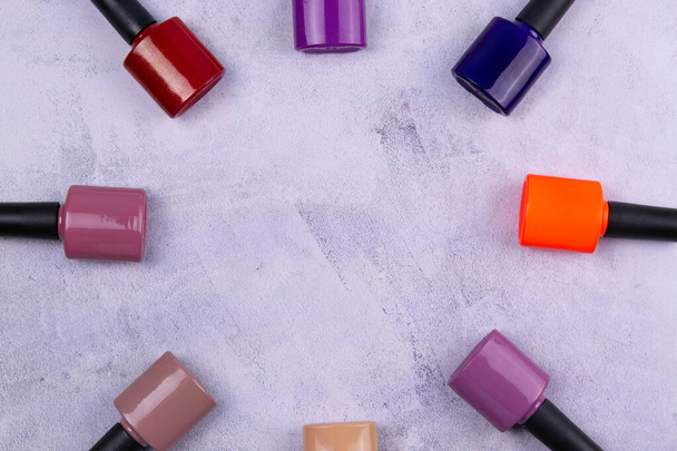 Background of multicolored nail polish samples. Top view of the color palette of nail services in beauty salon. Fashion manicure. Gel lacquer. Nail design - Photo, Image