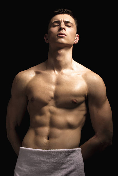 Sexy sport muscle strongface guy with white towel on black isolated  font background - 写真・画像