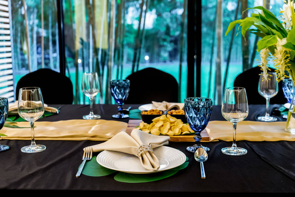 Luxuriöses Mittag- oder Abendessen auf dem langen Tisch mit schwarzem Muster - Foto, Bild