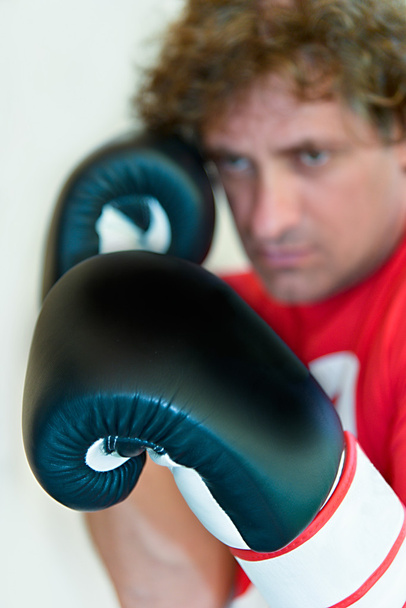 Man in red outfit with black boxing gloves - Foto, Imagen