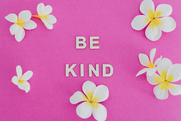 Be Kind message on pink background surrounded by flowers, concep - Fotó, kép