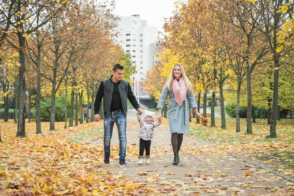 Happy family walking in autumn park - Photo, Image