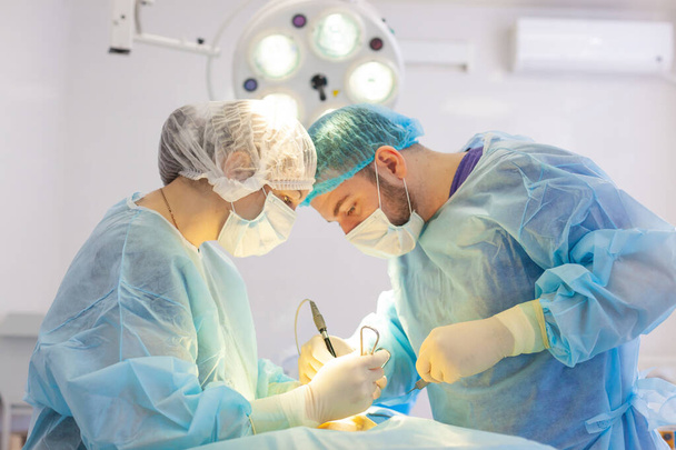Hospital. Surgeon operates in the operating room. Surgeons save life to the injured. - Valokuva, kuva
