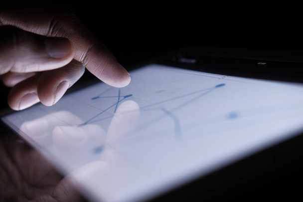 Close up of man hand analyzing chart on digital tablet  - Foto, Imagem
