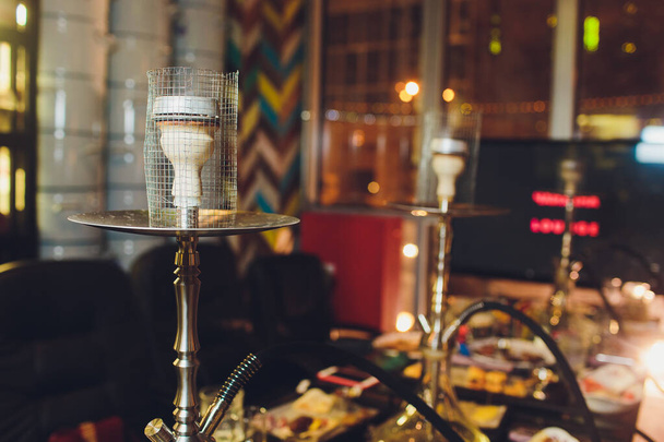 group of red hookahs shisha on table in interior. - 写真・画像