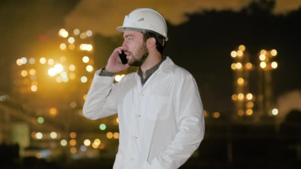 Engineer calling phone on chemical factory. - Video, Çekim