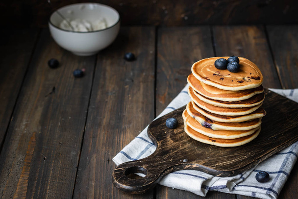 ricotta pancakes with blueberries on a dark wooden background - Фото, изображение