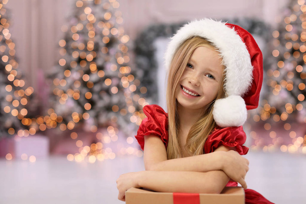 Cute little child with Christmas gift at home. Space for text - Photo, Image