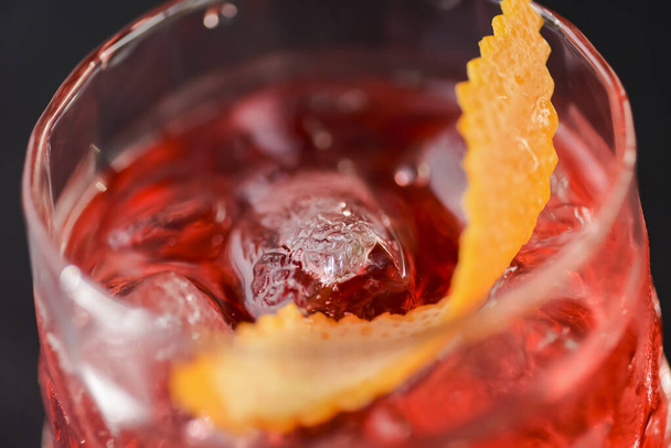 Fruit summer cocktail alcohol drink with ice and orange peel. - Fotografie, Obrázek