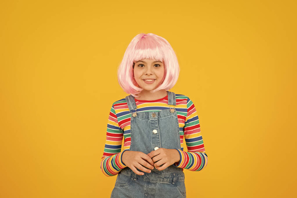 Otaku girl in wig smiling on yellow background. Cosplay character concept. Culture hobby and entertainment. Happy childhood. Anime fan. Cosplay kids party. Child cute cosplayer. Cosplay outfit - Φωτογραφία, εικόνα