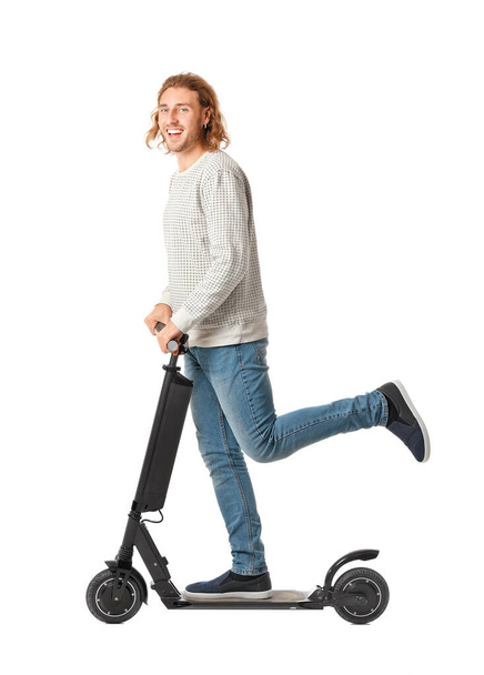 Young man with kick scooter on white background - Zdjęcie, obraz