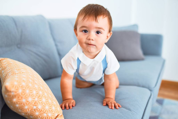 Adorable toddler sitting on the sofa at home - Φωτογραφία, εικόνα