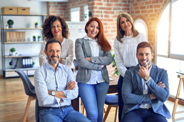 Grupo de empresários sorrindo feliz e confiante. Posando junto com sorriso no rosto olhando para a câmera no escritório - Foto, Imagem