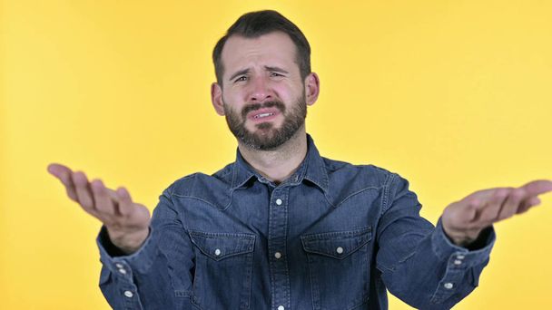 Portrait of Disappointed Young Man Reacting to Failure, Yellow Background - Foto, Imagen
