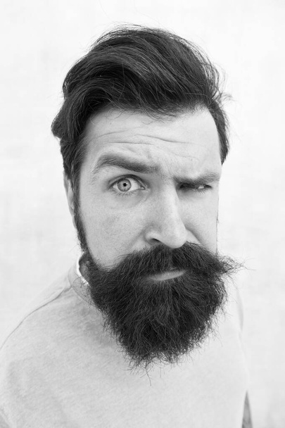 Suspicious look. Perceptions of male beauty. Stylish beard and mustache care. Happy face. Beard fashion barber. Handsome guy. Masculinity concept. Man bearded hipster stylish beard grey background - 写真・画像