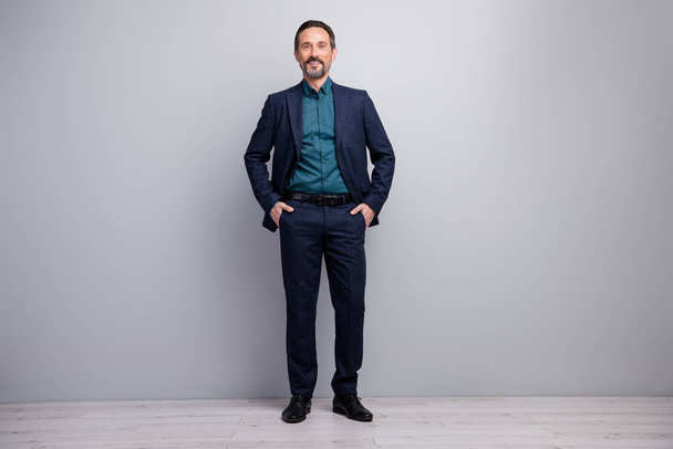 Full length photo of handsome business mature man hands in pockets well-dressed good-looking manager dressed formalwear shirt pants blazer suit isolated grey color background - 写真・画像