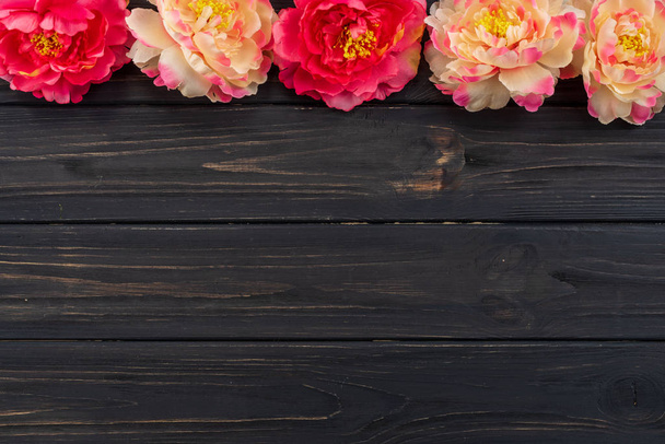 Beautiful fresh peonies on dark wooden surface - Fotoğraf, Görsel