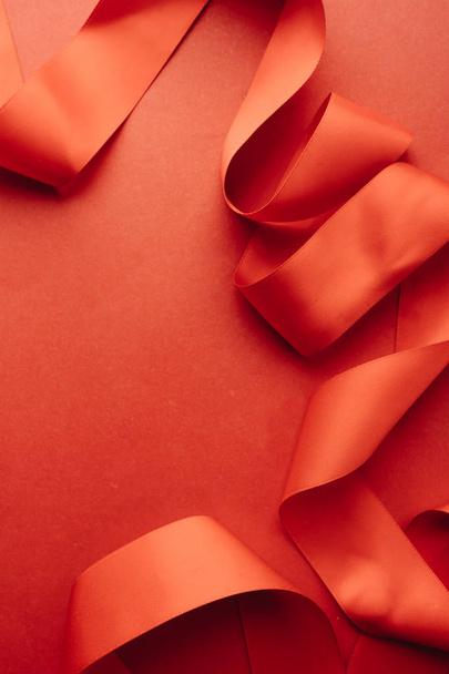 red ribbon decoration on red background - Foto, Imagen