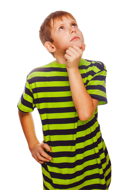 Blond kid boy in green T-shirt thinks scratching his head hair t - Фото, изображение