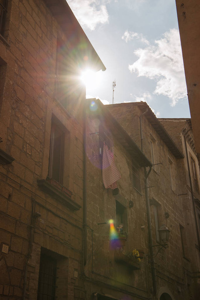 Sunlight between buildings in Orvieto, Rome suburb, Italy - Photo, Image