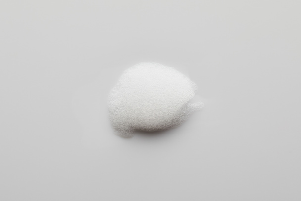 Top view of soap foam on grey background - Foto, imagen