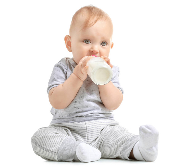 Baby with bottle of milk on white background - 写真・画像