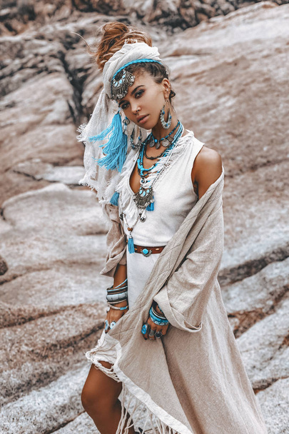 beautiful young woman in tribal costume with primal ornamet  - Foto, imagen