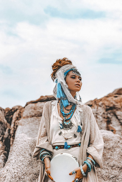 beautiful young woman in tribal costume with primal ornamet  - Fotografie, Obrázek