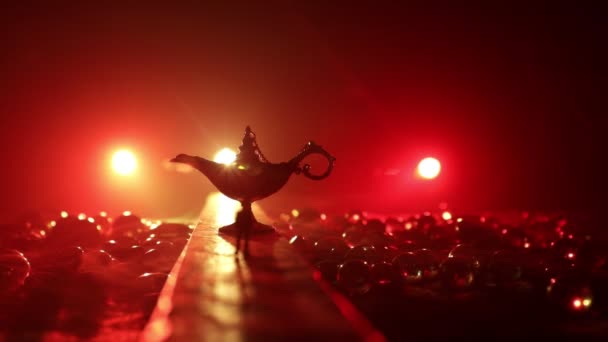 Lamp of wishes concept. Silhouette of a man standing in the middle of the road on a misty night with giant Antique Aladdin arabian nights genie style oil lamp. Creative artwork decoration - Video, Çekim