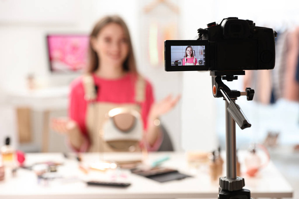Beauty blogger filming make up tutorial at home, focus on camera - Valokuva, kuva