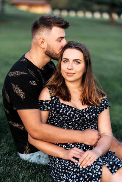 Portrait of a couple in love outdoors on the grass - Foto, Imagen