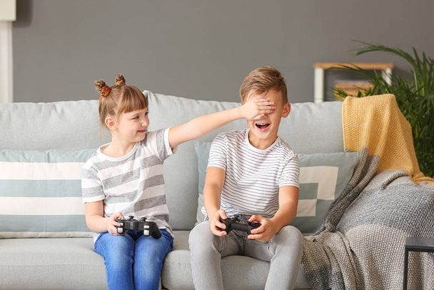 Little children playing video games at home - Photo, Image