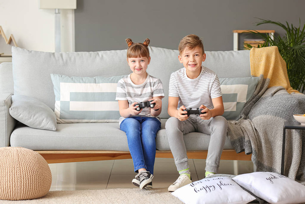 Little children playing video games at home - Photo, Image