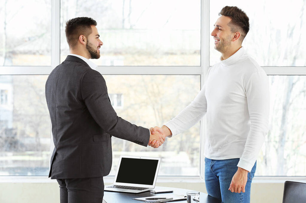 Bank manager and man shaking hands in office - Photo, Image