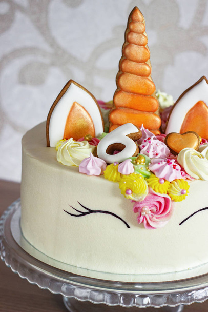 A beautiful bright cake decorated in the form of fantasy unicorn. The concept of a festive dessert for kids birthday - Photo, image