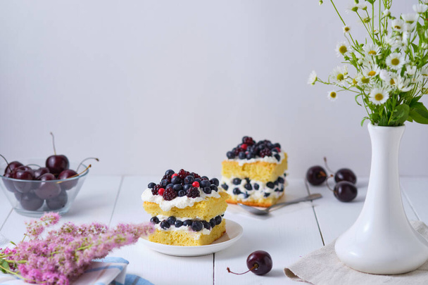 Sponge cake with fresh berries and curd cream for lovers. Summer romantic dessert. Surprise for the beloved. - Fotó, kép