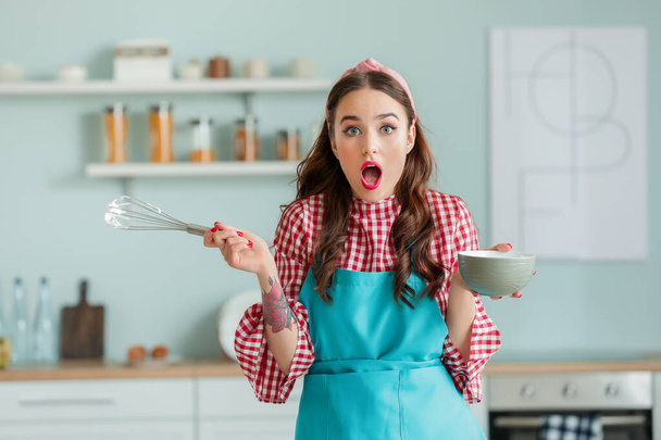 Funny housewife cooking in kitchen - 写真・画像