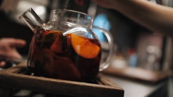 brewing tasty aromatic fruit tea with boiling water in a glass teapot - Felvétel, videó