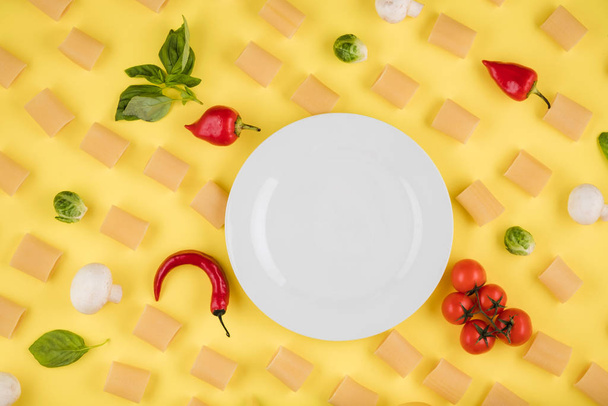 Ingredients for cooking arranged on a yellow background. Concept of italian cuisine - 写真・画像