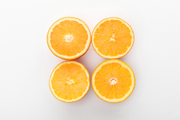 Top view of cut oranges on white background - Photo, Image