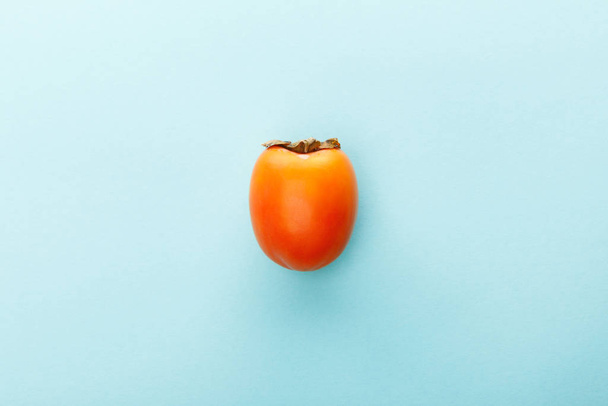 Top view of persimmon on blue background - Fotoğraf, Görsel