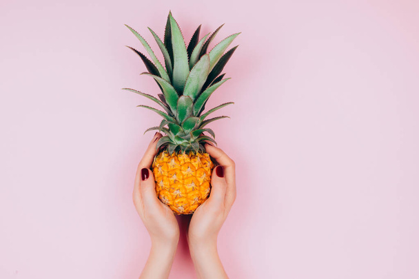 Hands with pineapple on stylish pink - Foto, afbeelding