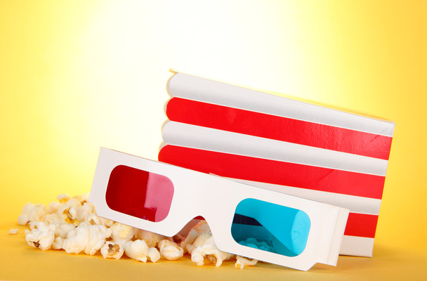 Popcorn and 3D glasses on yellow background - Фото, зображення