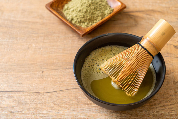 hot matcha green tea cup with green tea powder and whisk - Photo, Image