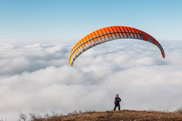 Pyatigorsk, Stavropol Territory / Russia - January 21, 2019: paraglider starting to paragliding above mountain - Photo, image