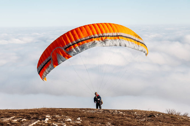 Pyatigorsk, Stavropol Territory / Russia - January 21, 2019: paraglider starting to paragliding above mountain - 写真・画像