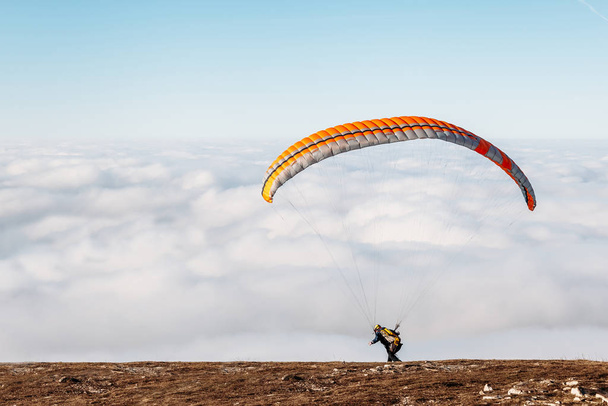 paraglider starting to paragliding above mountain - 写真・画像