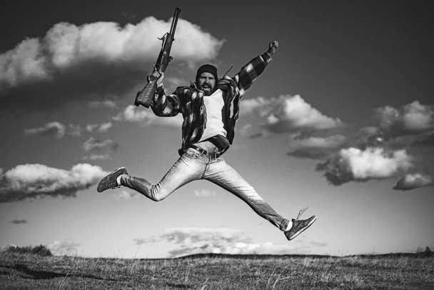Excited Hunter with shotgun gun on hunt. Crazy hunter on sky background. - Photo, Image