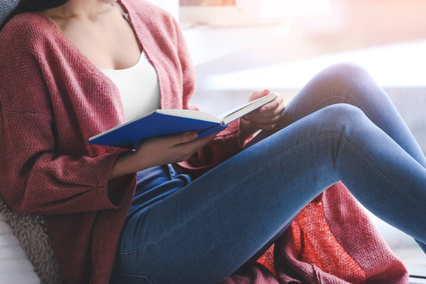Young woman reading book at home - Φωτογραφία, εικόνα