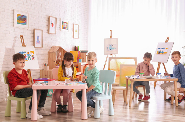 Cute little children painting at table in room - Φωτογραφία, εικόνα